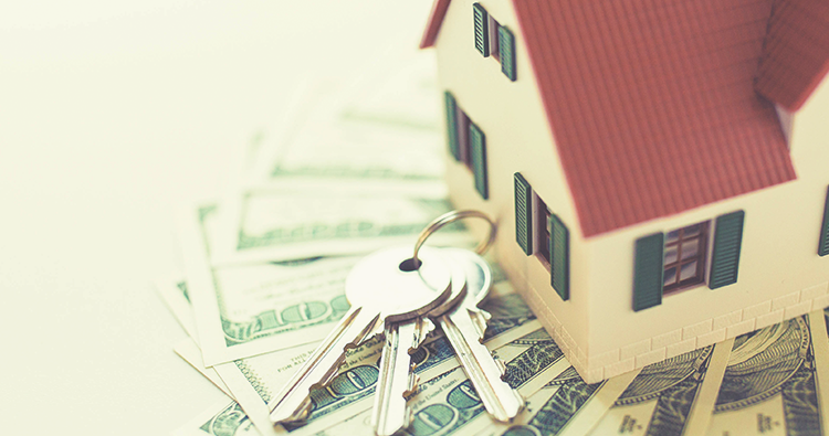 Home Loan image with small house and set of keys sitting on money
