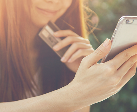 A girl using mobile banking on her Iphone