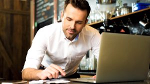 Man working on his laptop at his small business