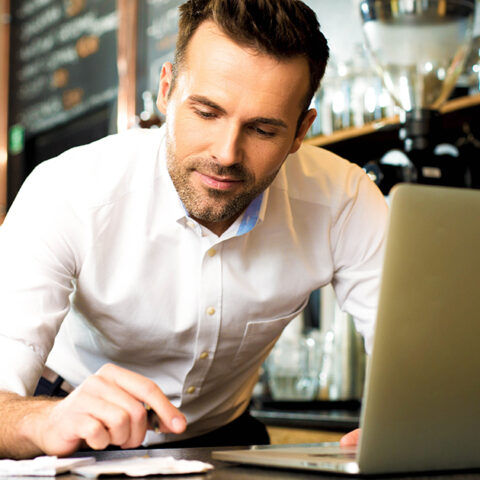 Man working on his laptop at his small business