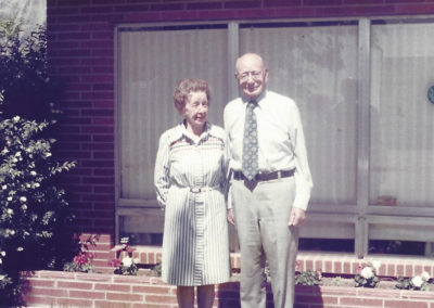 Harold Olsen and his wife standing outside
