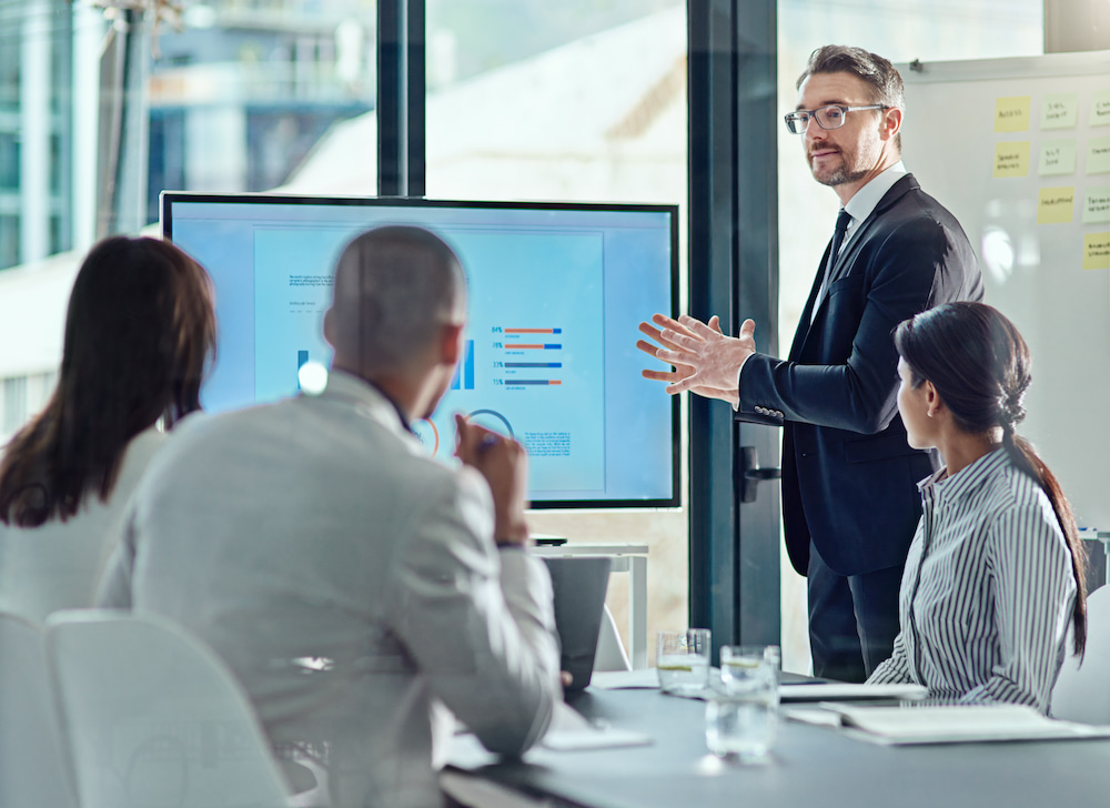 Four business people meeting for a presentation.